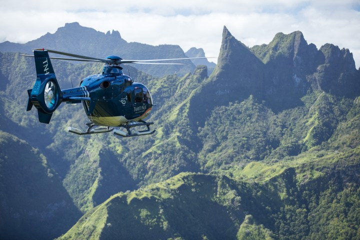 a man flying through the air while riding a motorcycle down a mountain